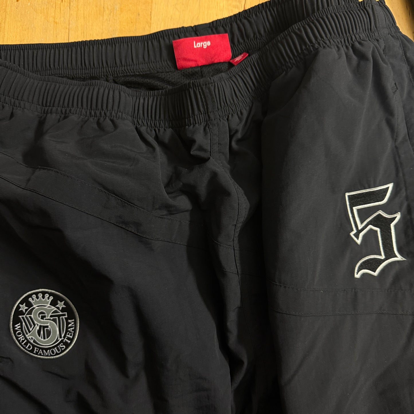 SUPREME SS25 OLD ENGLISH TRACK PANT