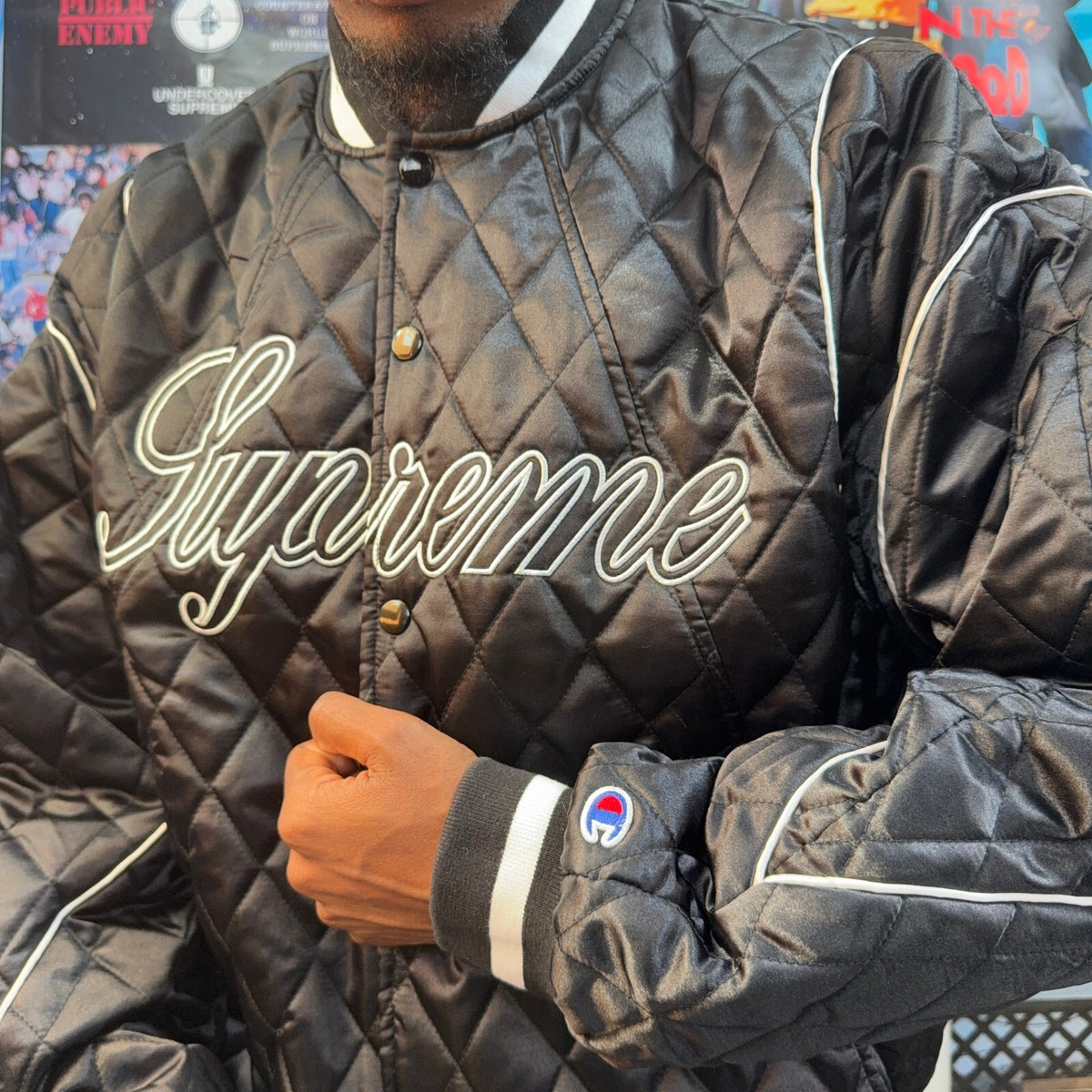 SUPREME FW26 CHAMPION QUILTED SATIN VARSITY BLACK JACKET